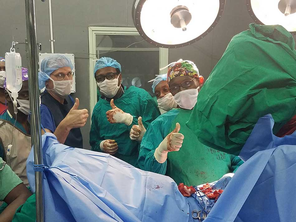 Dr. Glen Crawford with orthopedic surgeons thumbs up after successful operation at KCMC, Moshi T